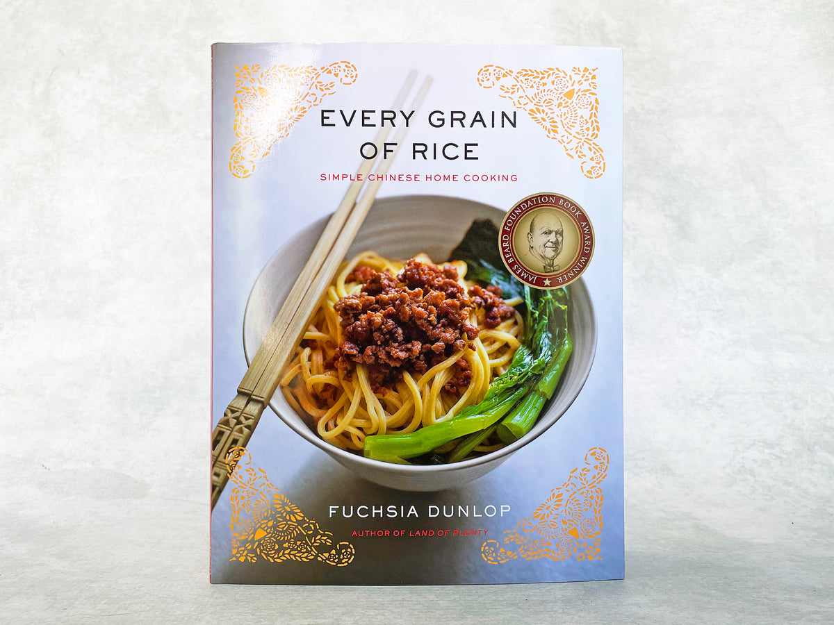 the front cover of a hardback cookbook showing a bowl of noodles and chopsticks