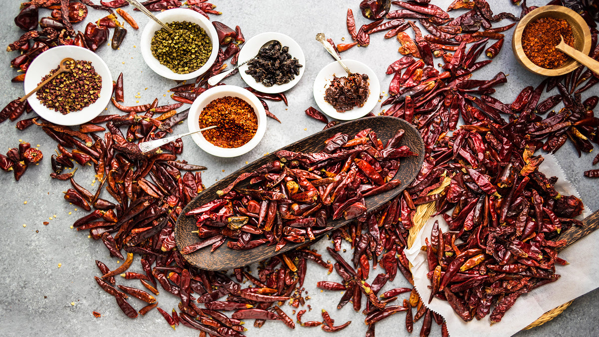 Dried red chilies and spices in bowls