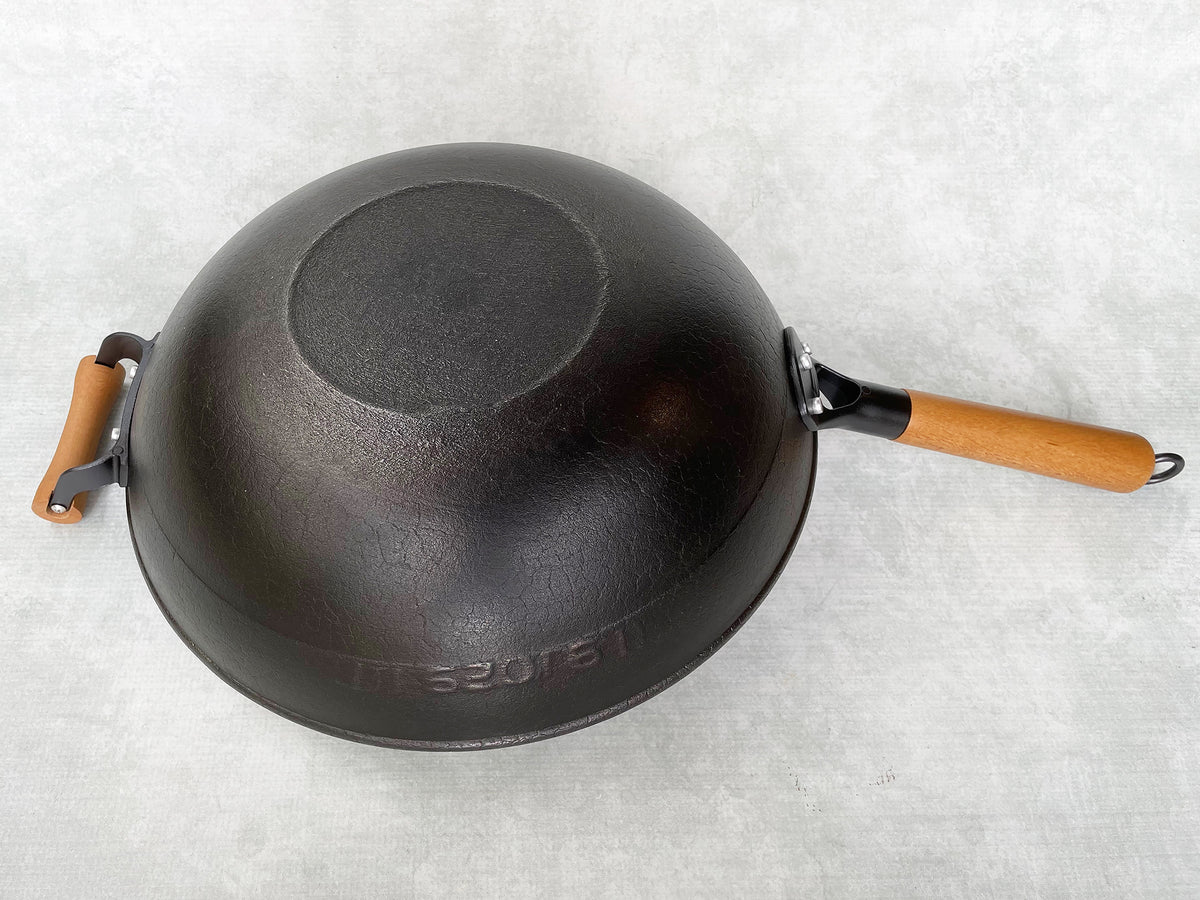 flat bottom cast iron wok shown upside down