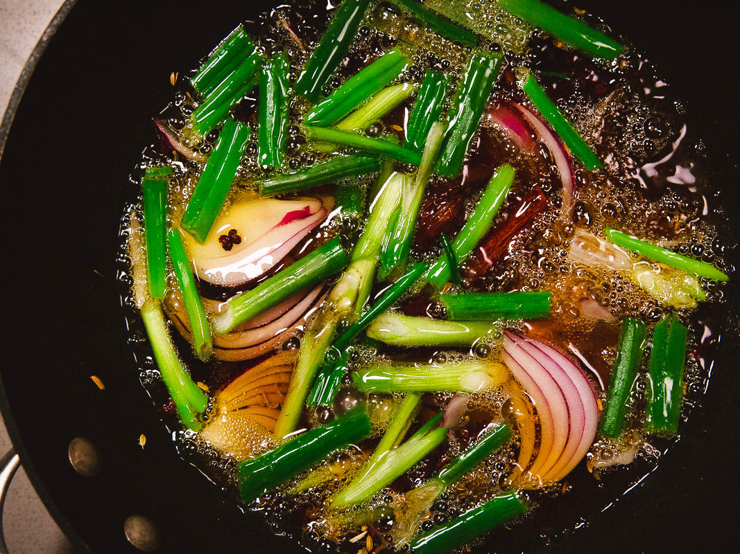Onions sizzling in oil in a wok