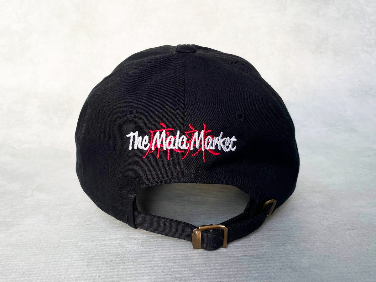 black cotton cap with The Mala Market logo embroidered in red and white on the back