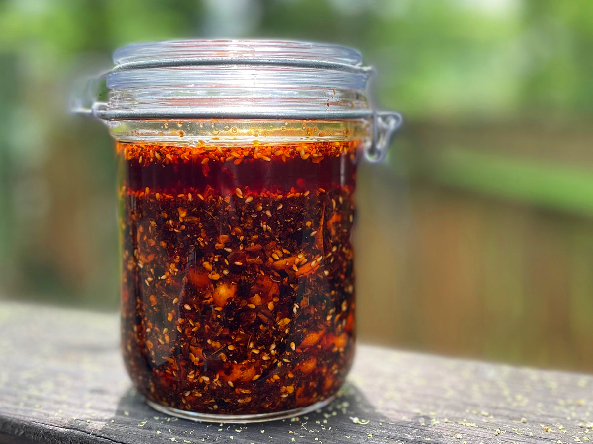 A glass jar of red chili crisp