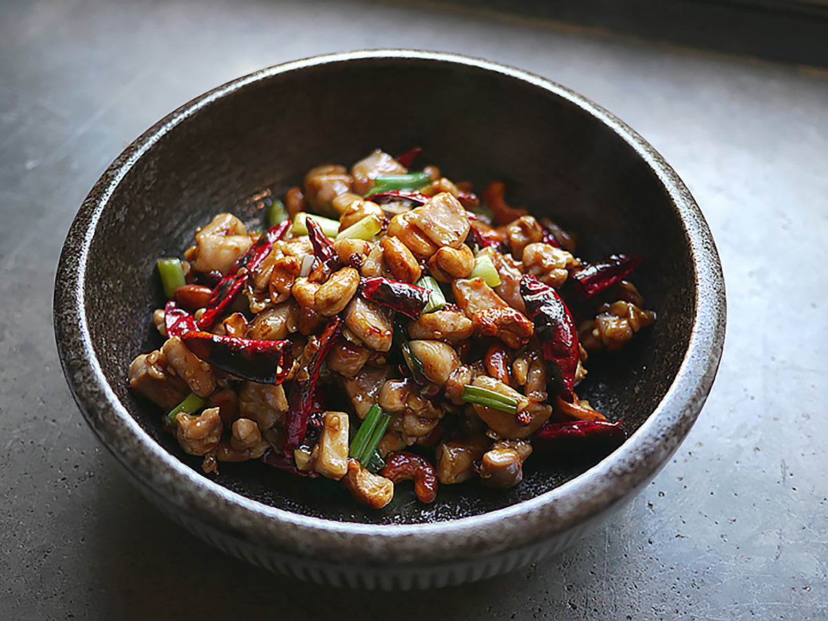 Gong bao chicken in a stoneware bowl