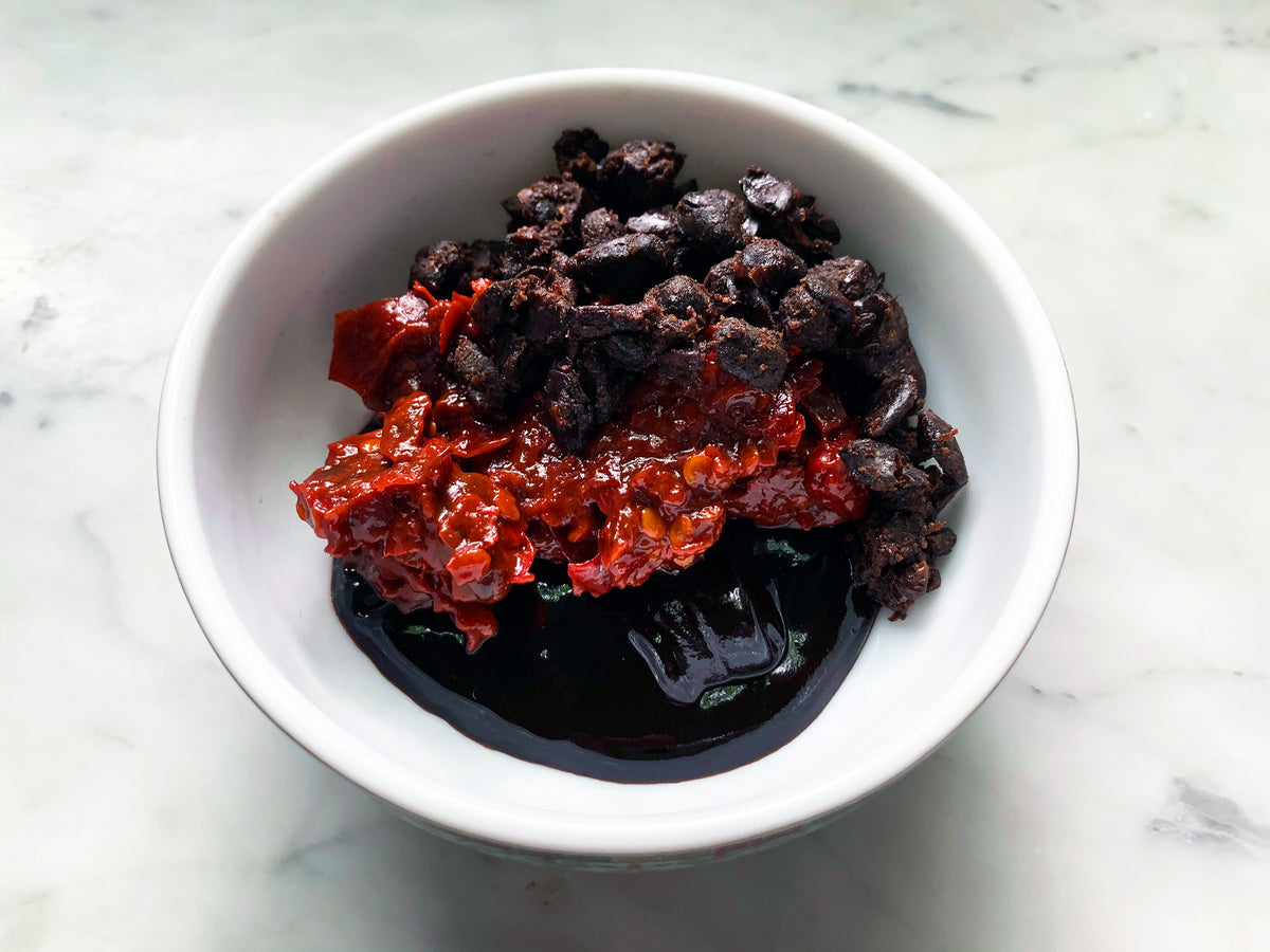A bowl holding fermented soybeans, red-oil doubanjiang and sweet wheat paste