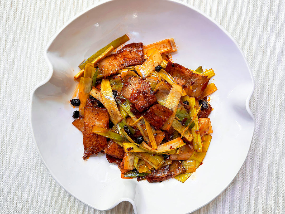 A dish of twice-cooked pork belly with leeks