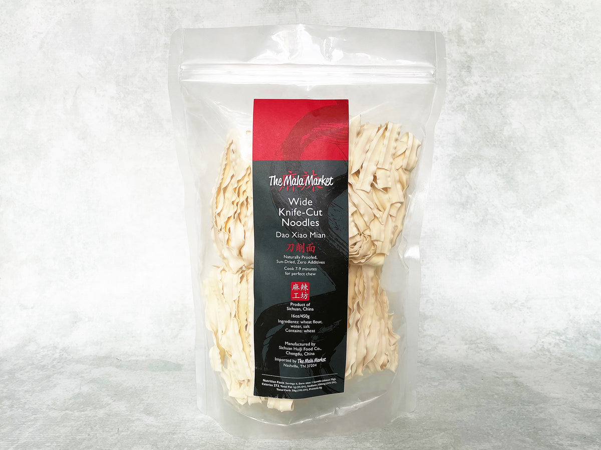 Packaged bundles of knife-cut noodles (Sun-Dried Dao Xiao Mian) in a clear plastic, resealable bag 