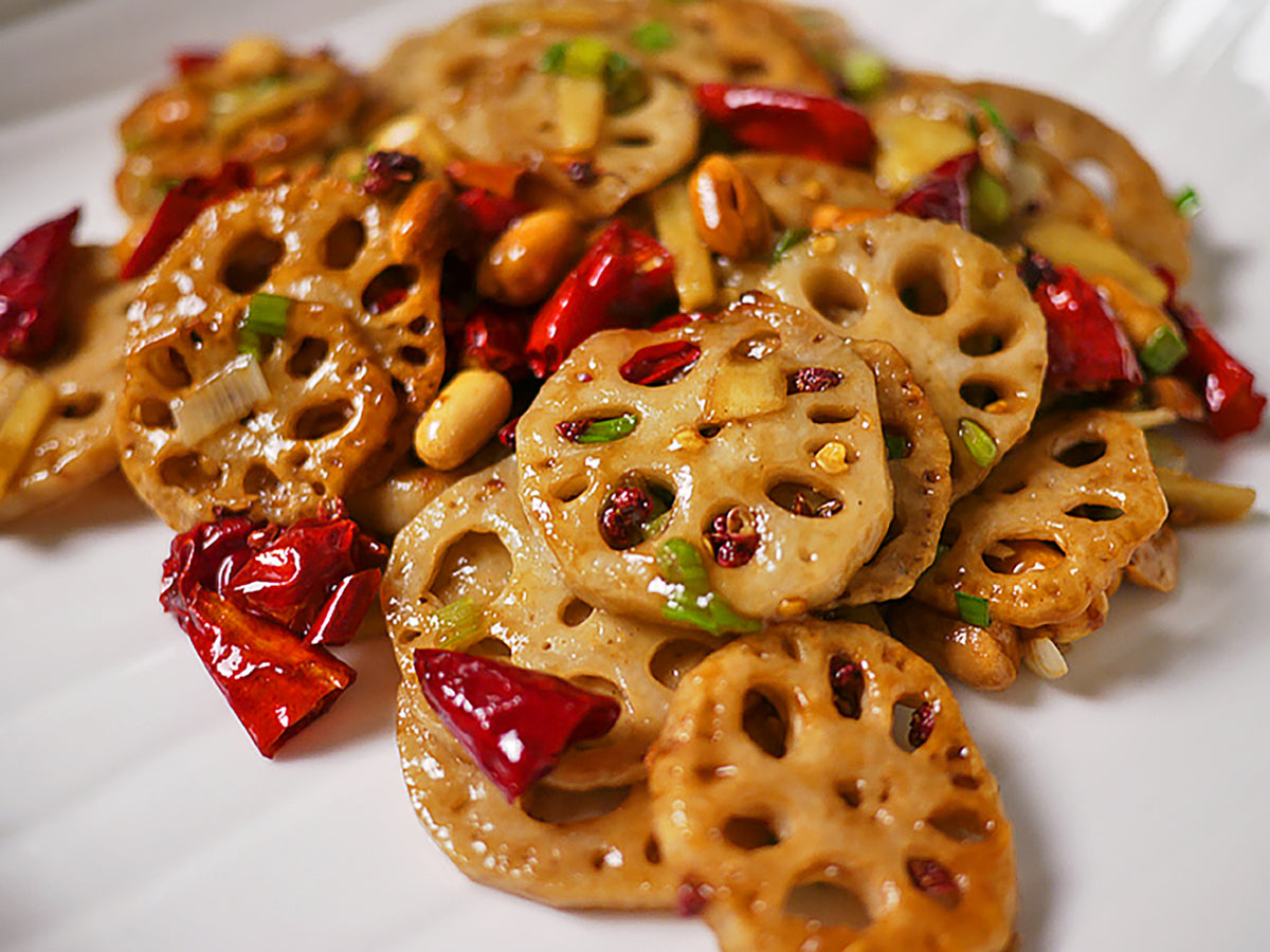 Kung pao lotus root in a glistening glaze with chilies and peanuts