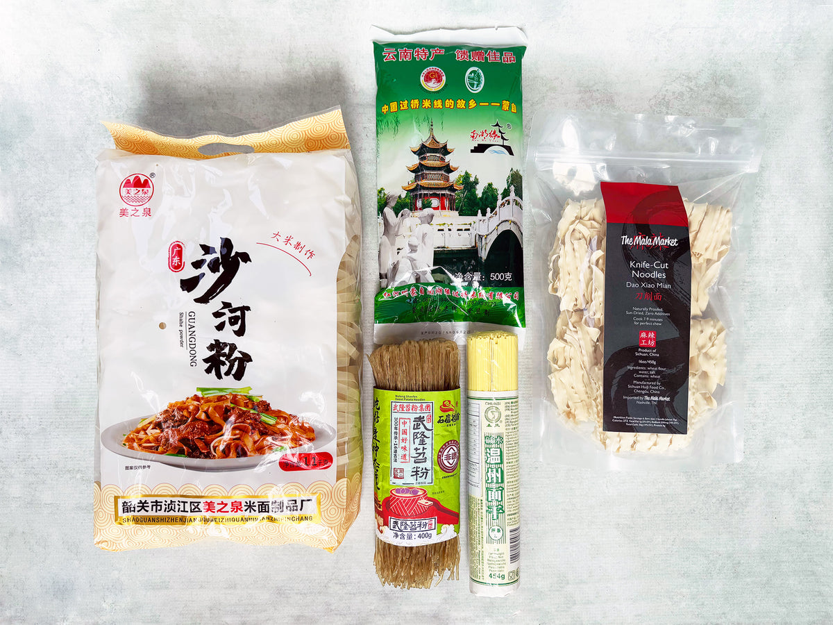 a collection of five kinds of dried Chinese regional noodles including wheat, rice and sweet potato of different sizes