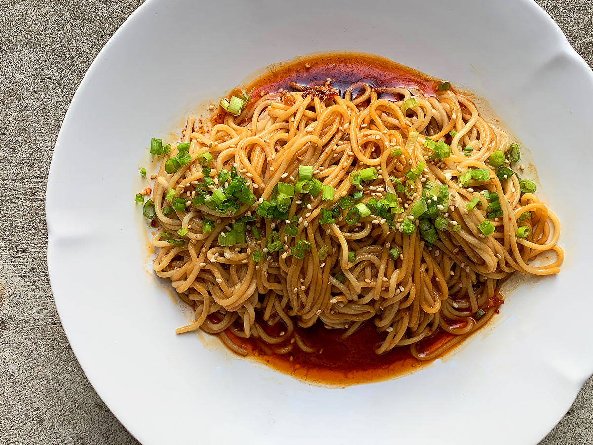 Sesame noodles in a white bowl
