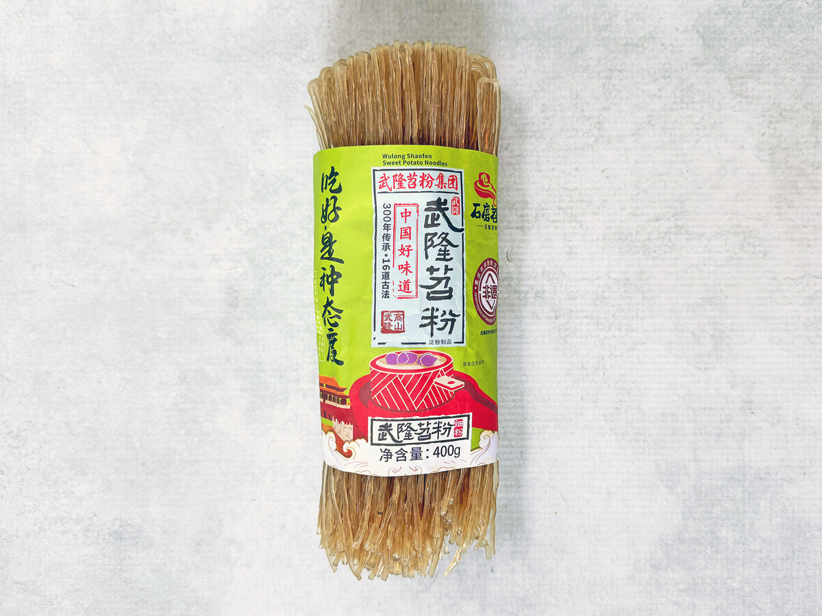 a roll of brown noodles with a paper label