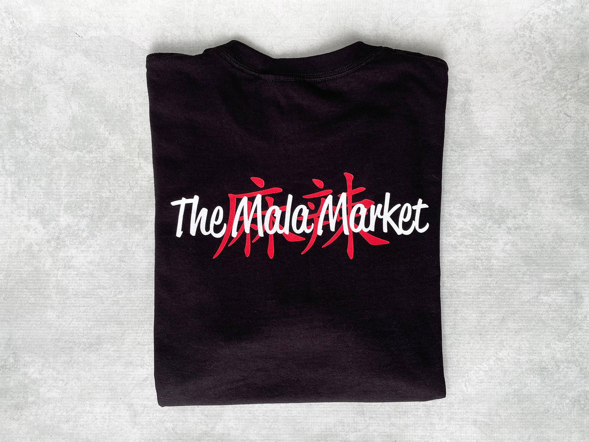a black folded t-shirt with the Mala Market logo on the back