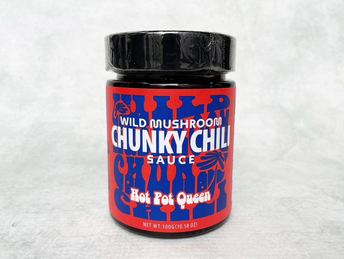 a glass jar with a red and blue label holding Hot Pot Queen mushroom chili oil 