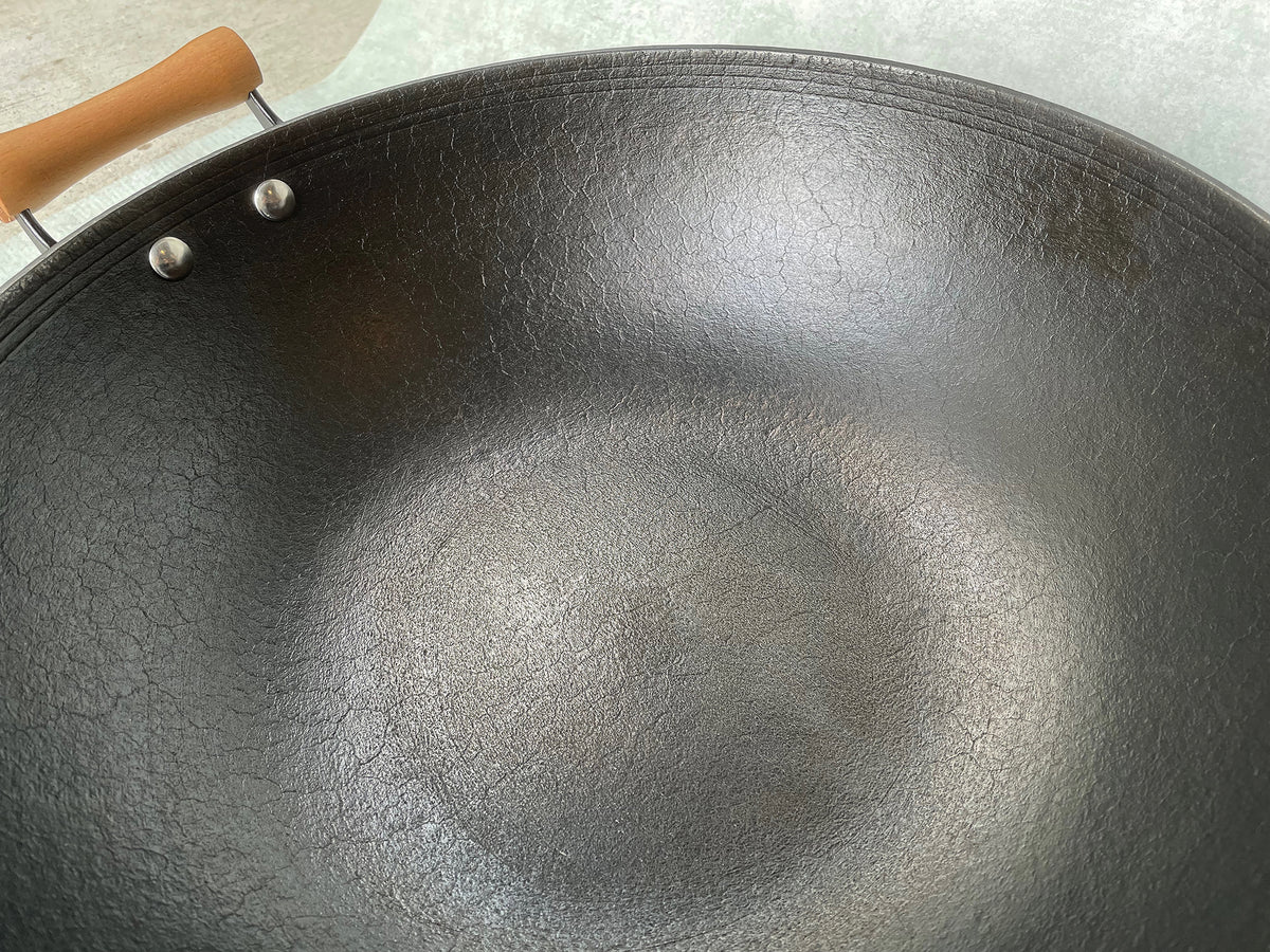 a closeup of the interior of cast iron wok showing metal pattern