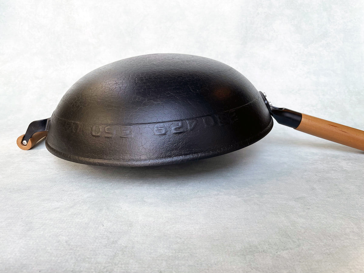 an upside down round bottom cast iron wok