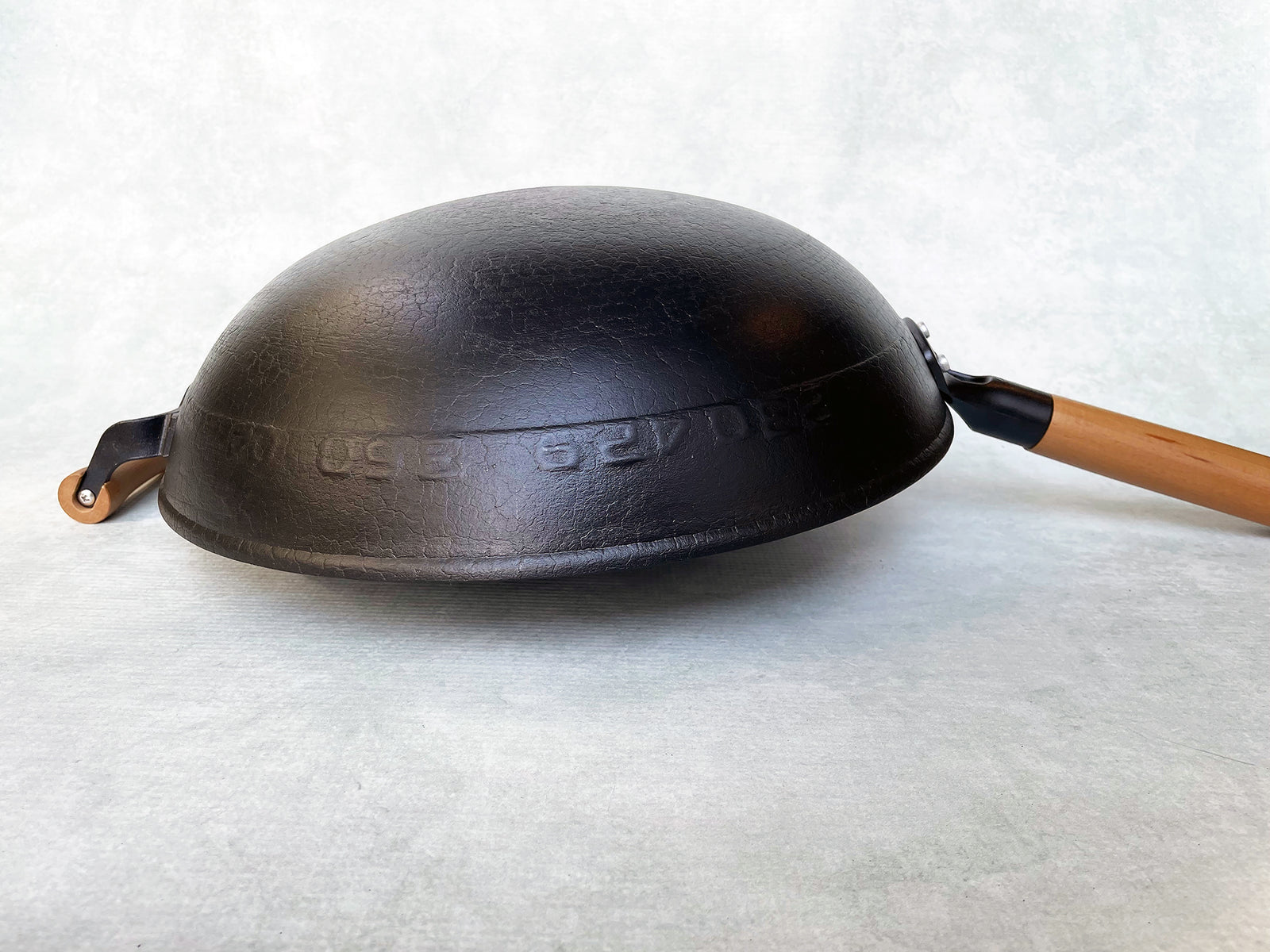 an upside down round bottom cast iron wok