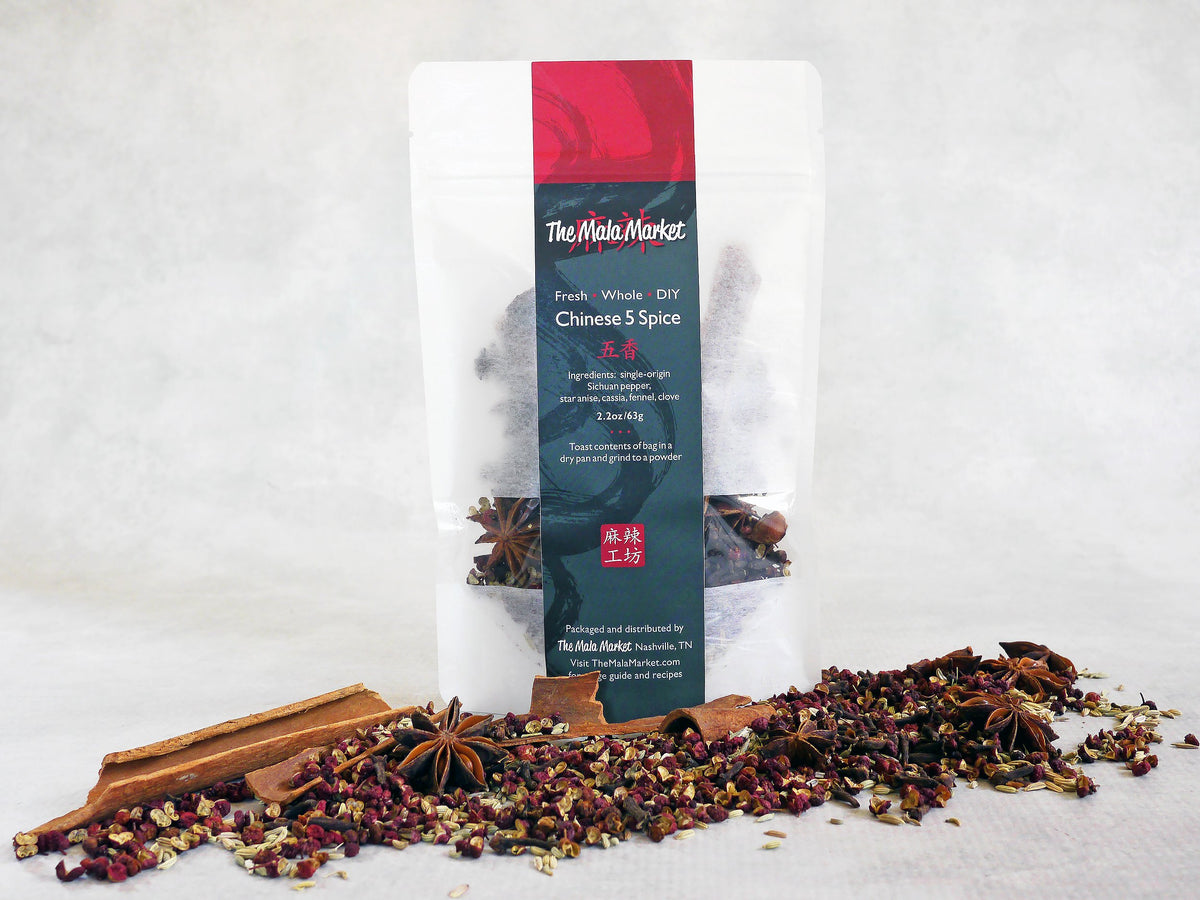 a white kraft bag of Chinese 5 spice with the whole spices also displayed in front of  the bag