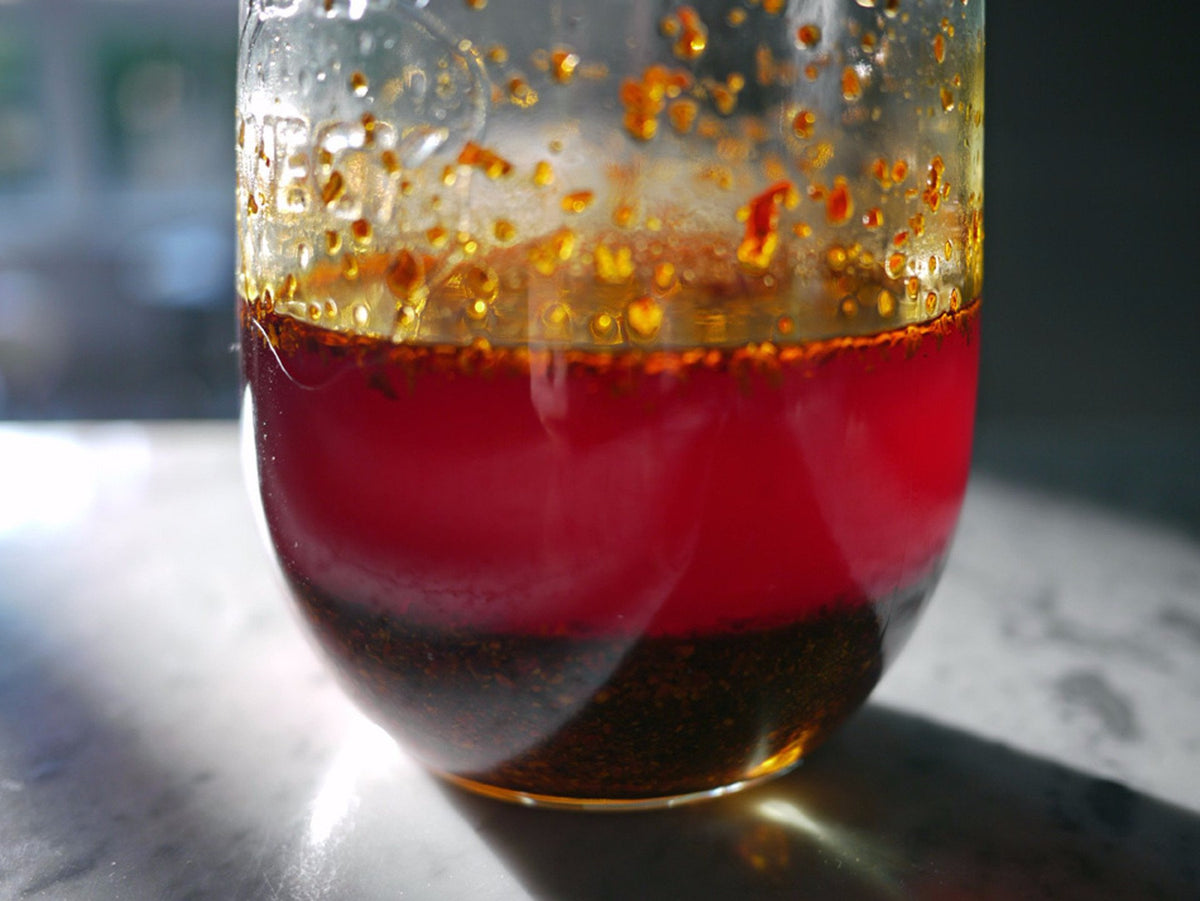 a closeup of a jar of red chili oil made with ground chilies