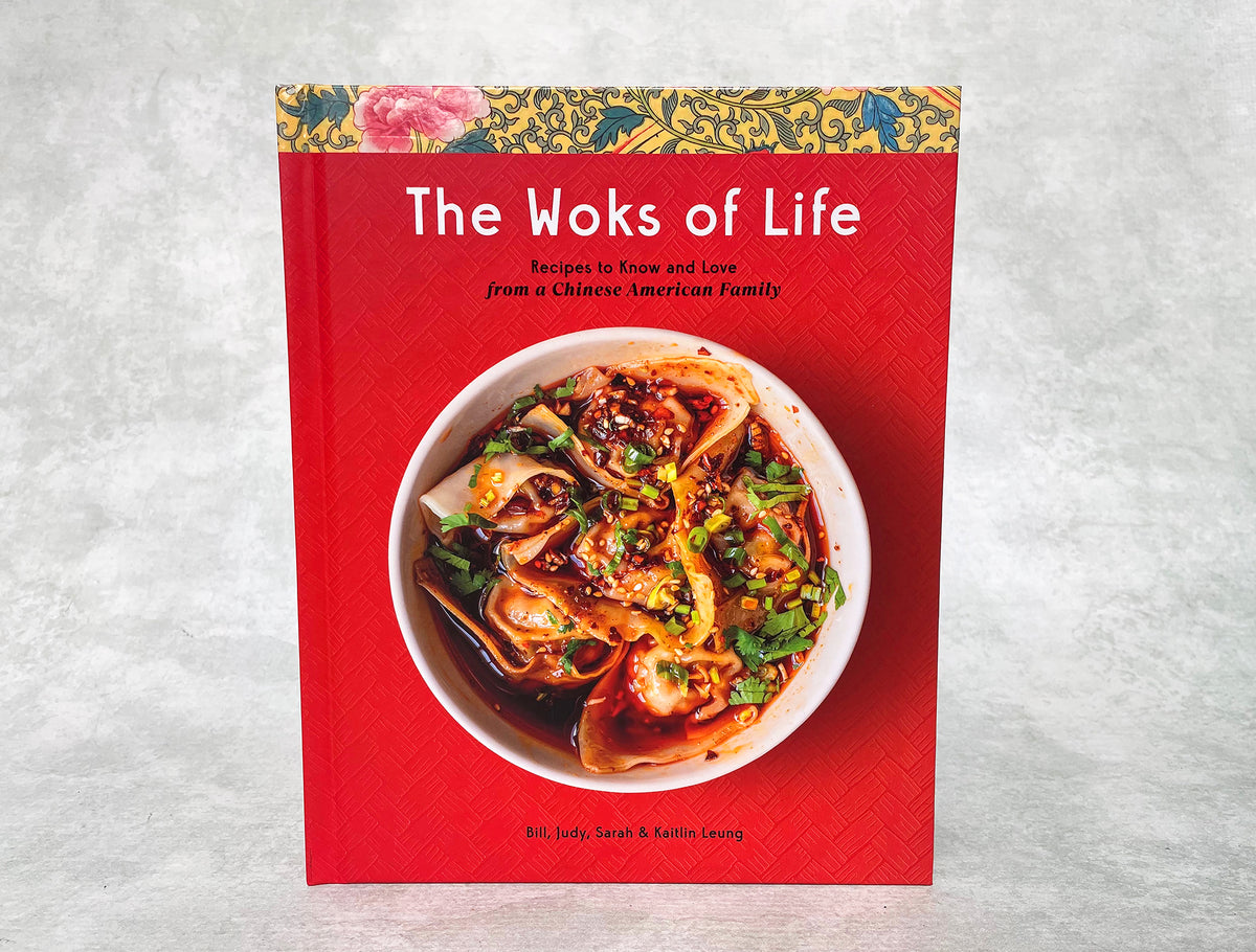 a hardback copy of The Woks of Life cookbook by the Leung family, showing a bowl of dumplings