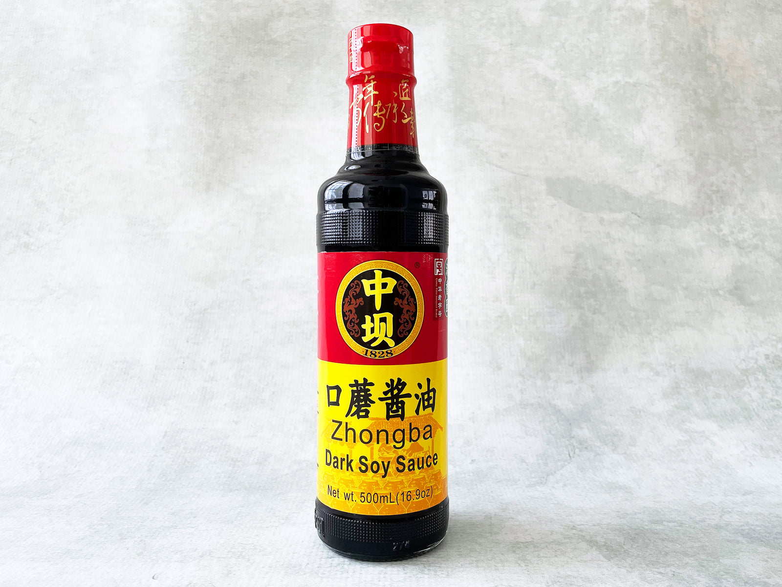 a glass bottle of Zhongba dark soy sauce with a red and yellow label