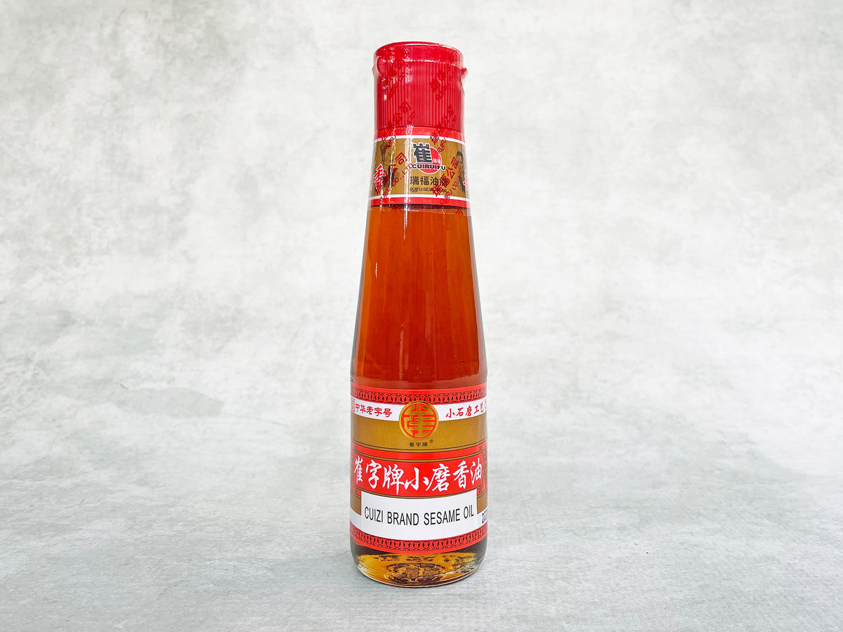 a small glass bottle of golden-brown oil 