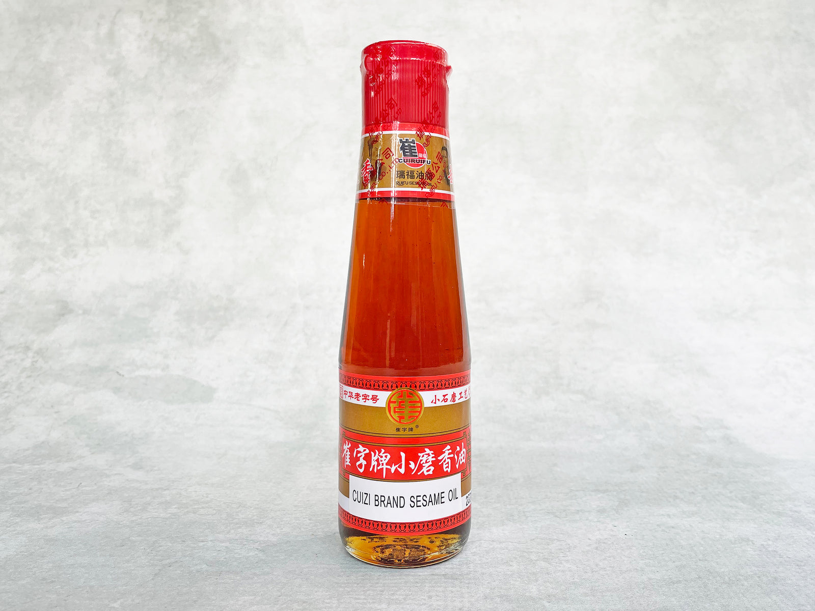 a small glass bottle of golden-brown oil 