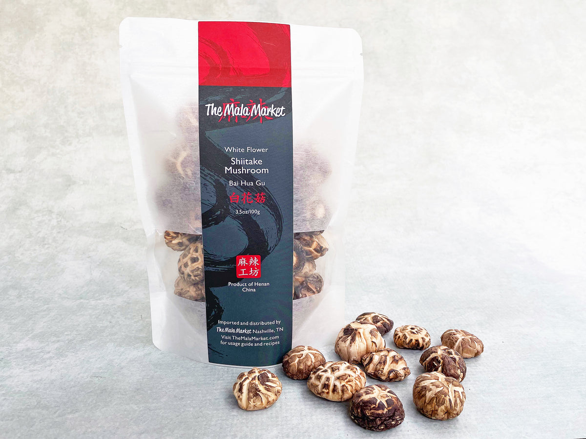 dried brown mushrooms with white cracks on the top, displayed in front of their white kraft bag