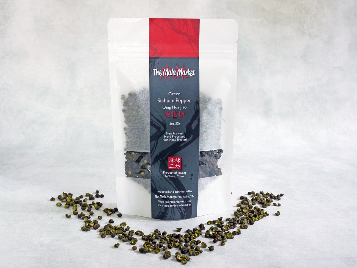 white Kraft bag full of spice with green peppercorns displayed in front of it