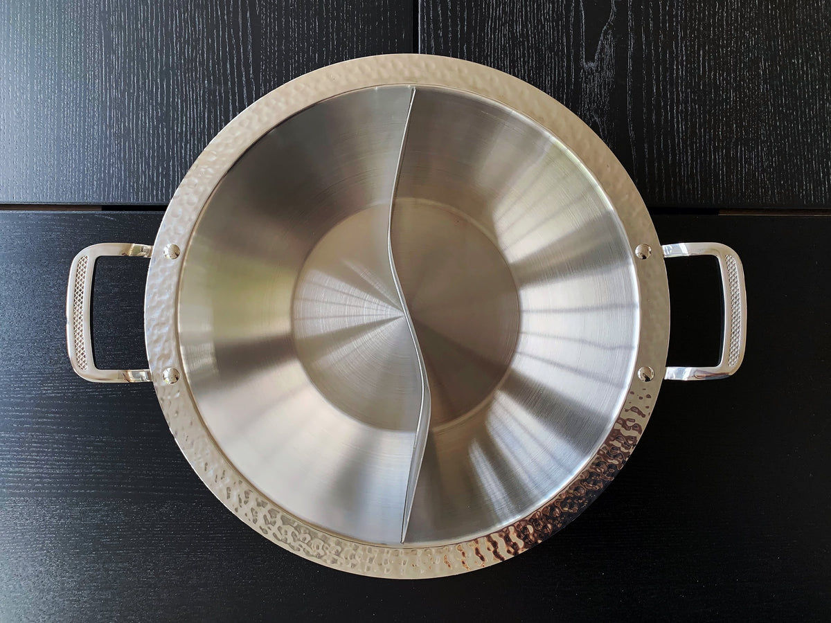 overhead view of a flaring bowl-shaped stainless steel hot pot with a flat bottom 
