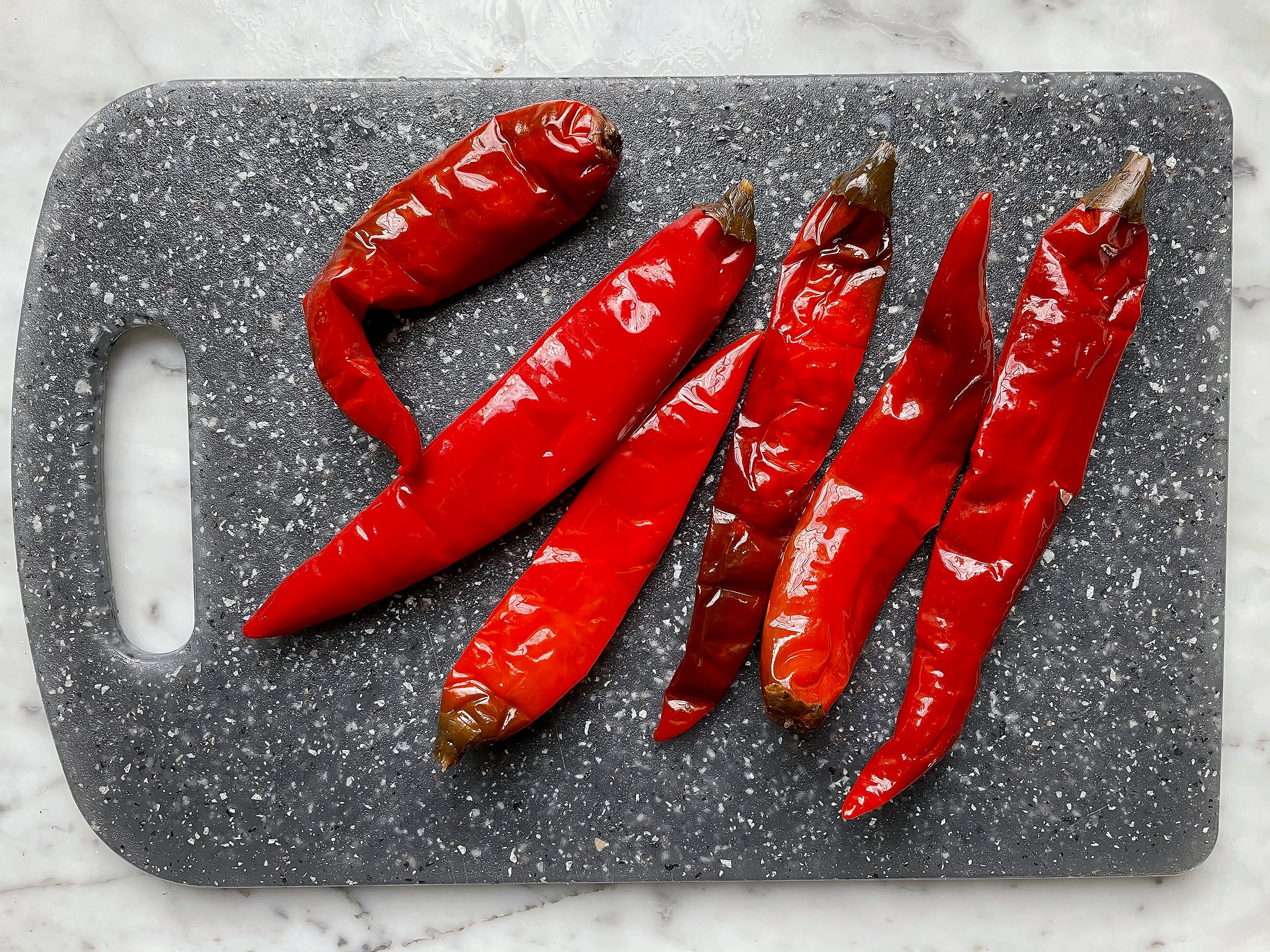 Sichuan pickled chilies (pao la jiao) on cutting board