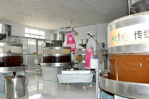 the sesame paste factory and stone mills grinding sesame seeds