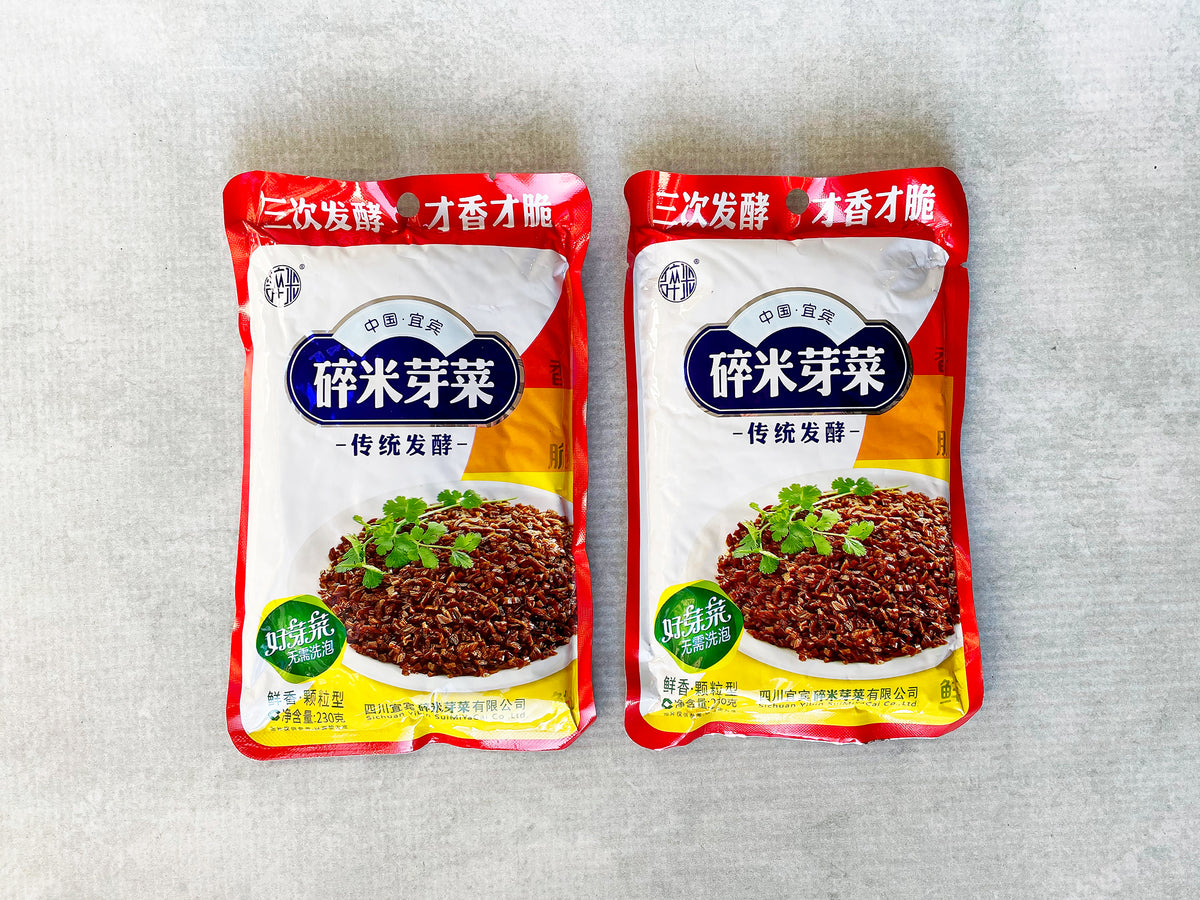 two foil packages of Yibin yacai preserved mustard stem, with photo of the pickle on the front cover