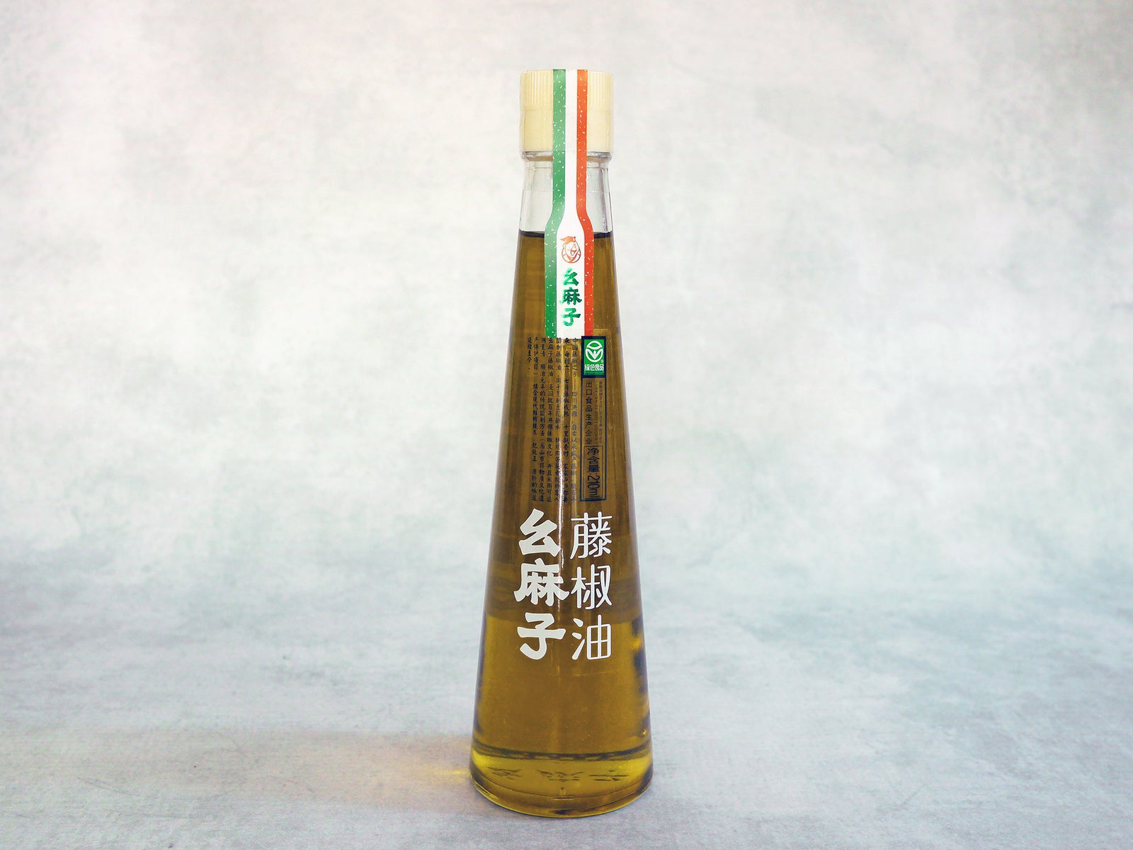 a long tapered bottle with golden Sichuan pepper oil and a clear label 